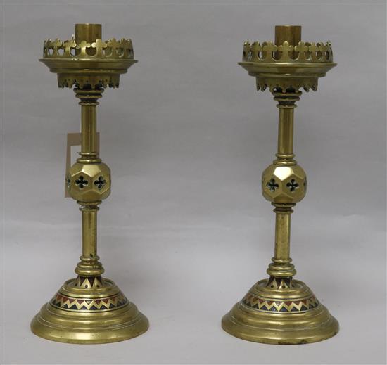 A pair of brass enamelled Victorian gothic candlesticks height 30cm